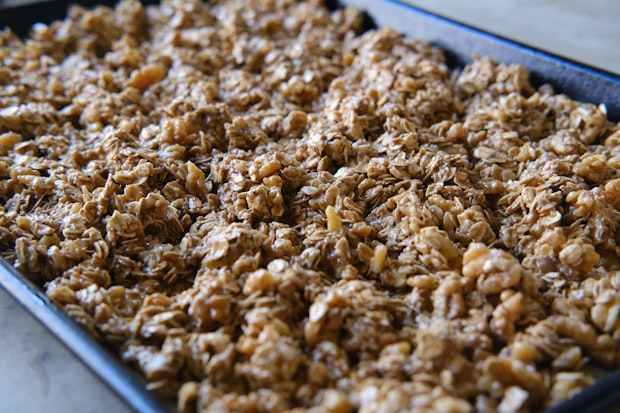 sourdough granola on a sheet pan before baking