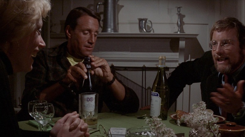 Ellen, Martin, and Hooper sitting at a dinner table in Jaws