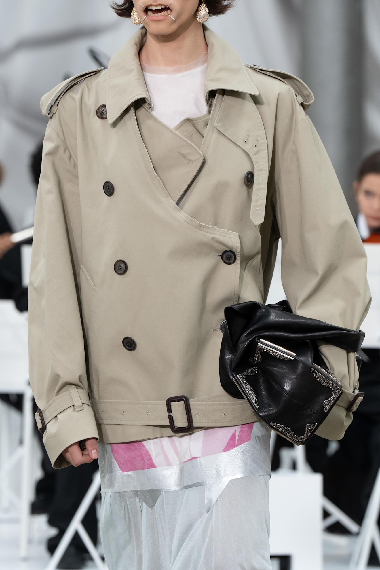A close-up image of a model at the S/S 26 Maison Margiela show carrying a slouchy, oversized bag.