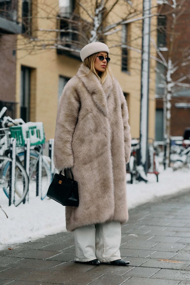 Photo of woman wearing coat at Copenhagen Fashion Week.